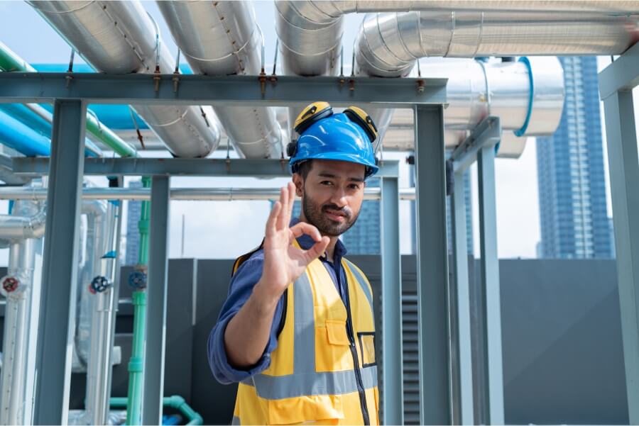 hvac-technician-inspecting-pipes-on-rooftop.jpg