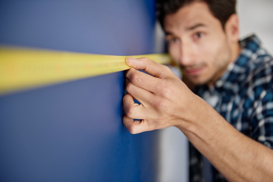 precise-hvac-technician-measuring-wall.jpg