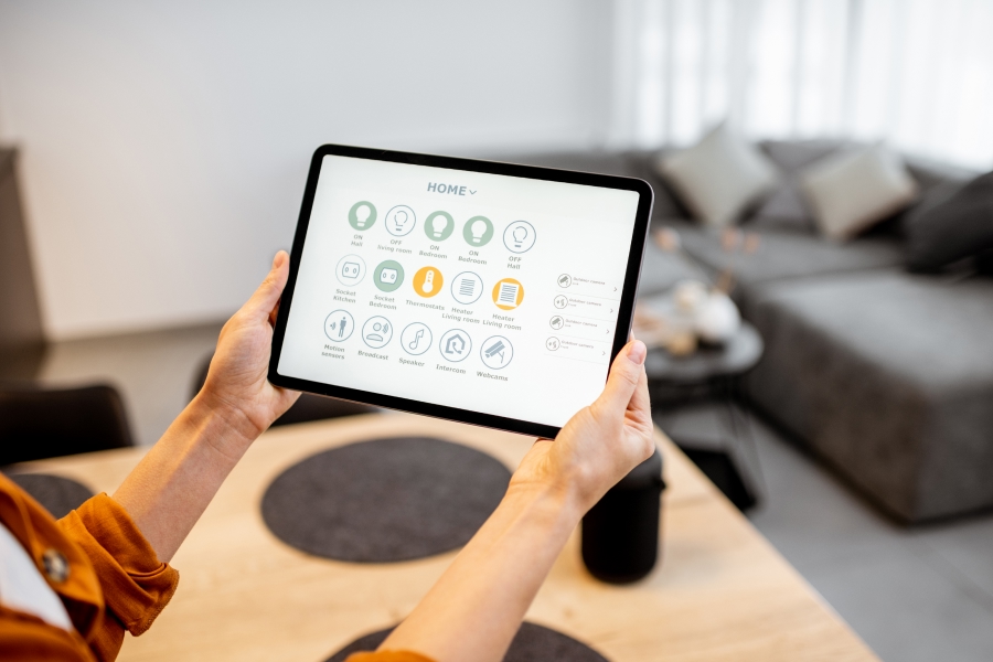 woman controlling temperatura with smart device tablet